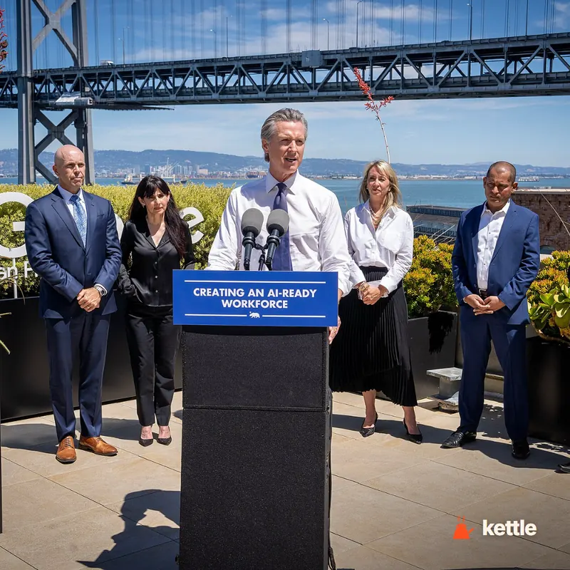Gavin Newsom speaking at a podium labeled 'Creating an AI-Ready Workforce' with the Bay Bridge in the background, flanked by four other people