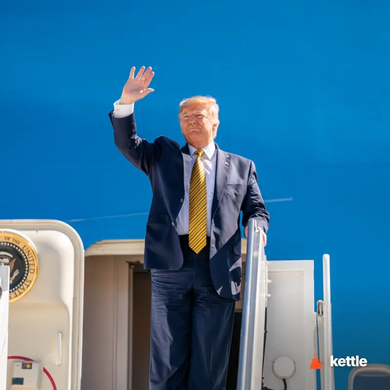 Donald Trump waving while descending the stairs of Air Force One/Presidential aircraft